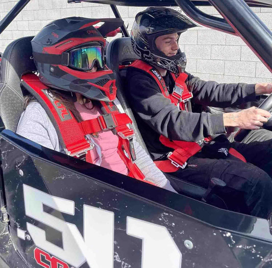 50 Caliber Racing push-release buckle shown for quick release.